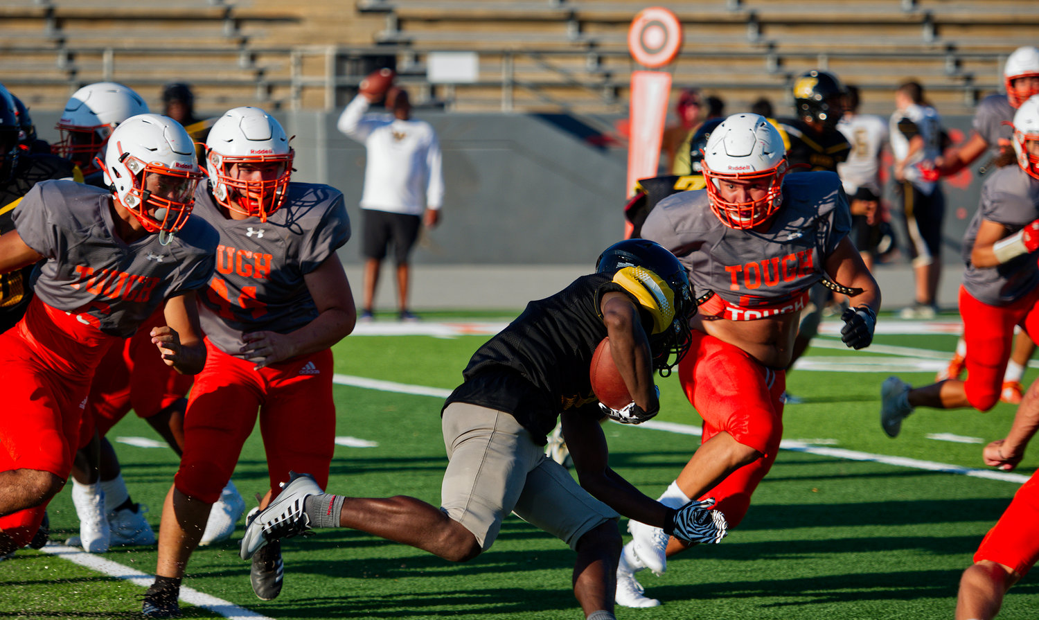 Mineola Yellowjacket defenders swarm to the Winona ball carrier during Friday’s first scrimmage of the 2022 high school football season.